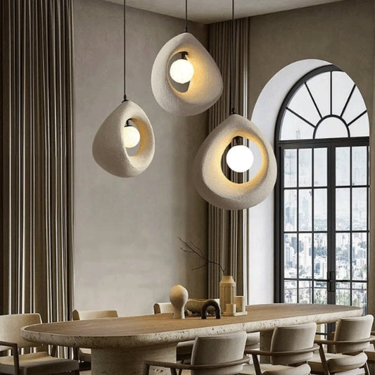 white wabi sabi cave surround ball pendant light above dining table