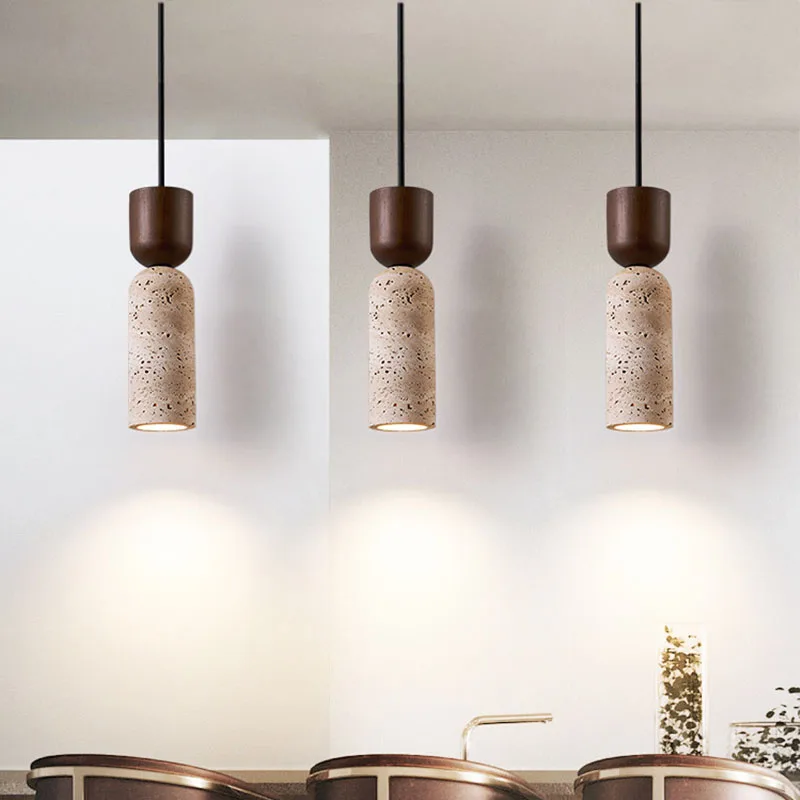 3 Auren Cylinder Stone and Wood Pendant Lights over Wabi Sabi dining table