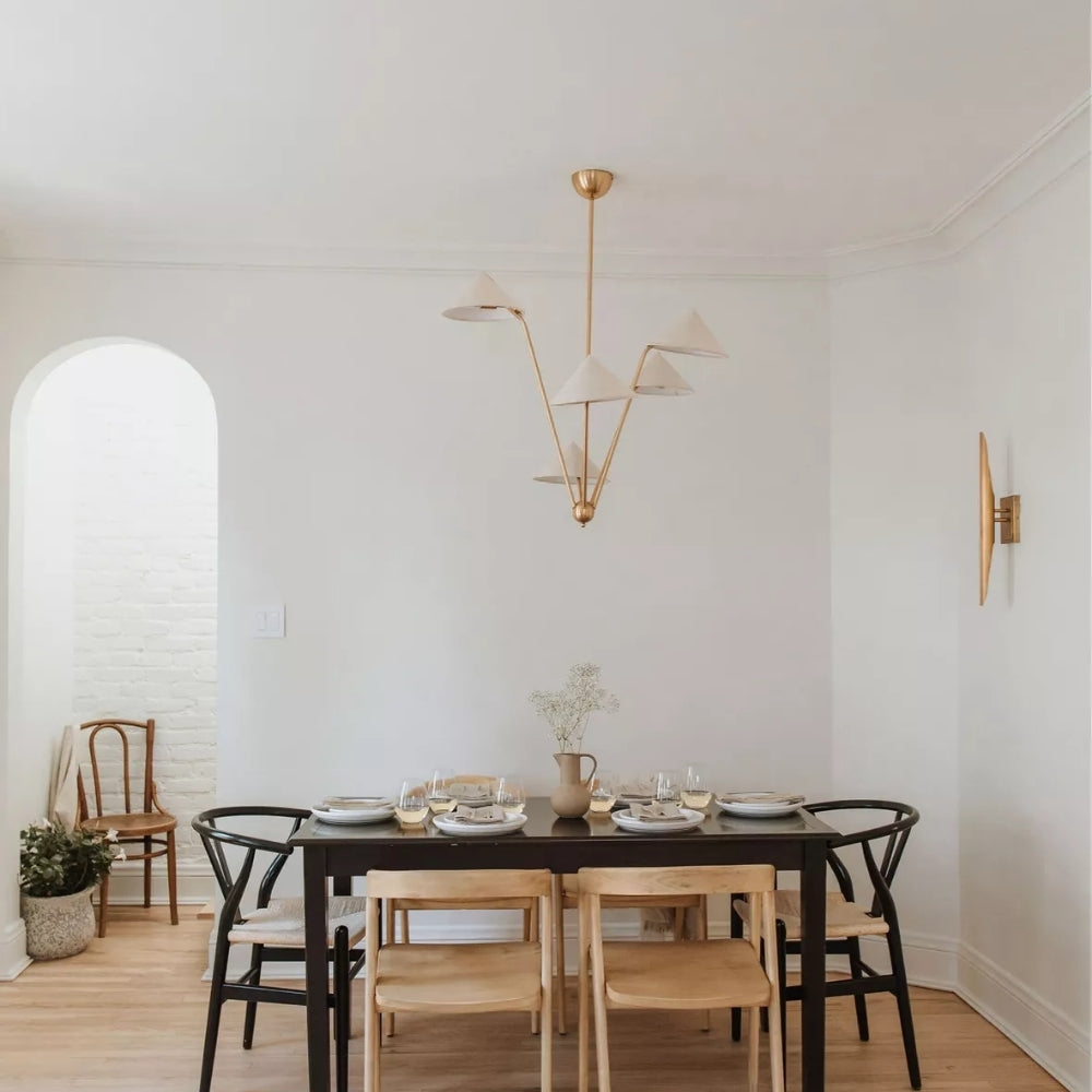 Wabi Sabi Cone Fabric Ceiling Light in dining room, five tapered arms spreading wide above the tabletop as a grounded centerpiece over place settings