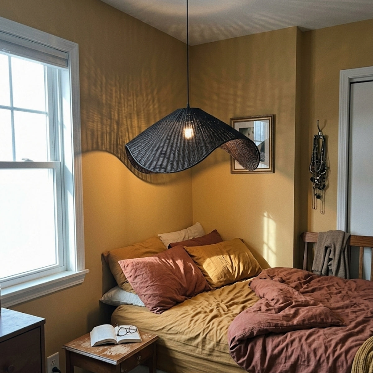 Adaya Black Wicker Rattan Pendant Light in bedroom, small shade with tight wave curve keeping the glow low and soft beside the nightstand