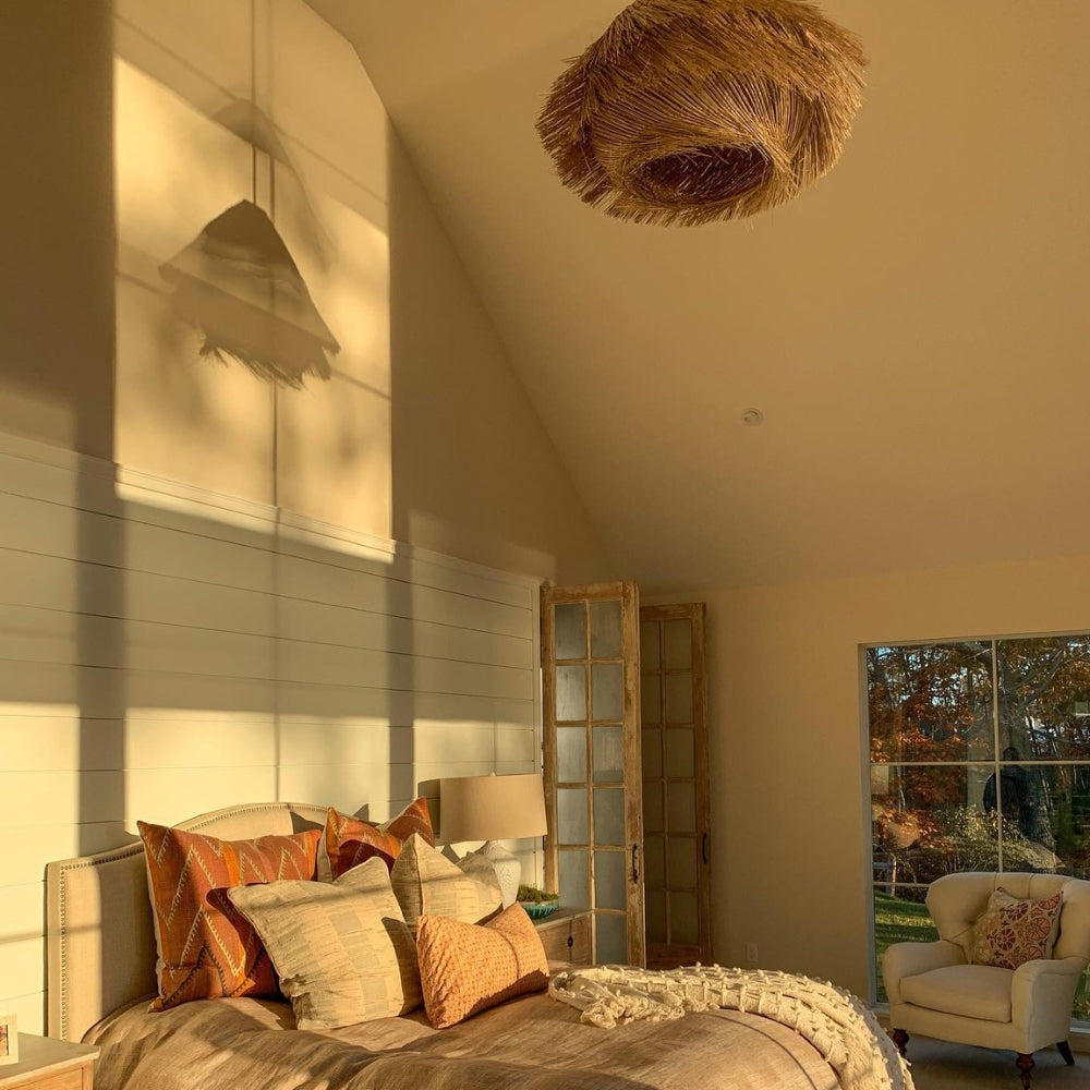 Ashburn Fringe Rattan Pendant Light in bedroom, 15.7-inch fringe hung above the nightstand filtering warm honey-toned light for reading in bed