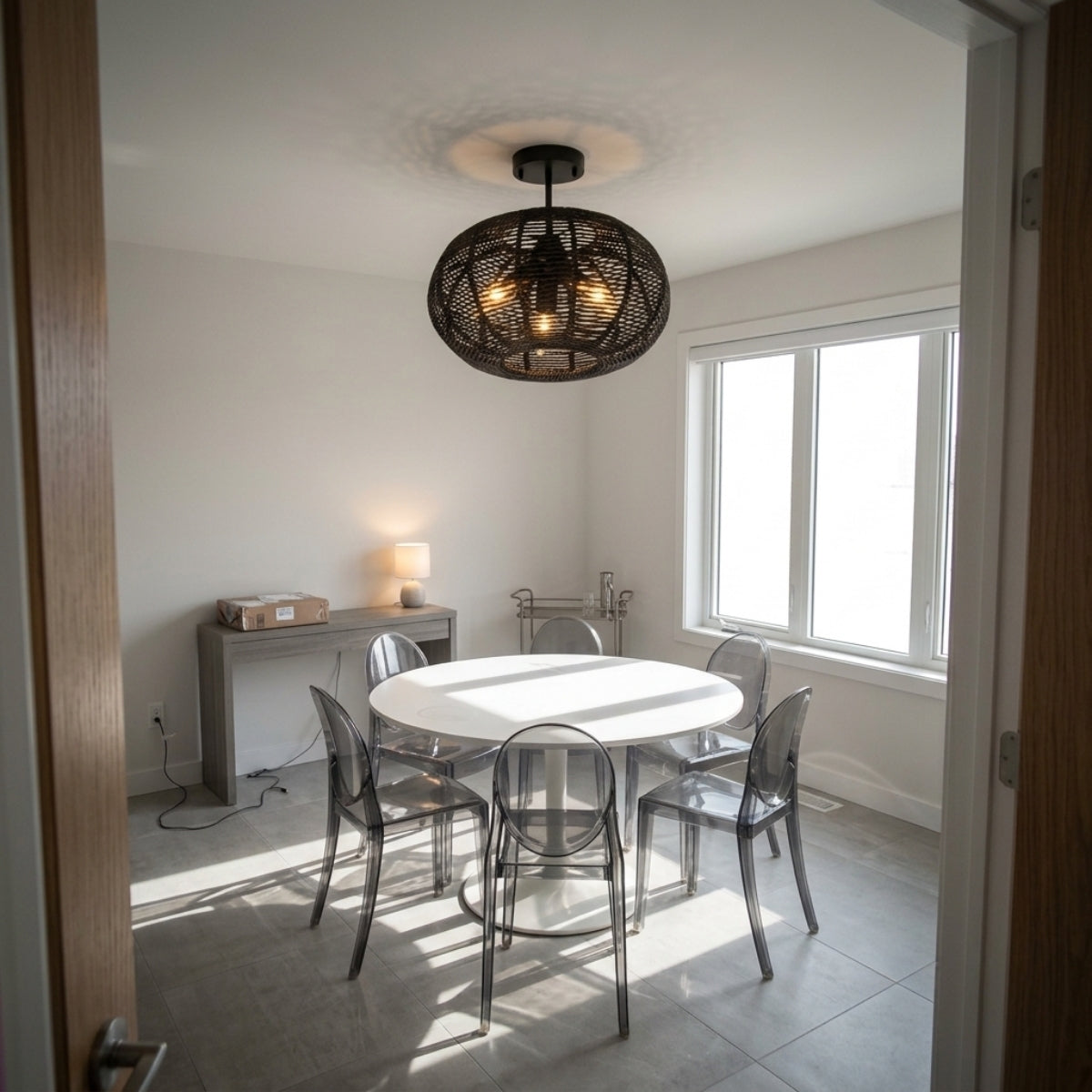 Cashmere Black Round Rattan Light Fixture above dining table, flush black dome covering a six-seat table without crowding sightlines across it