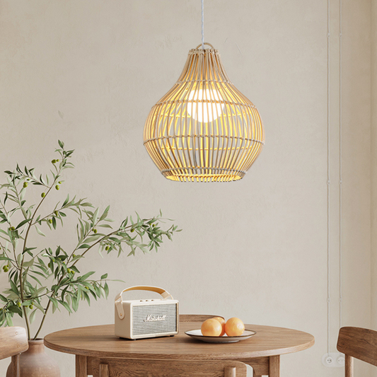 Dari rattan pendant light hanging over a wooden dining table