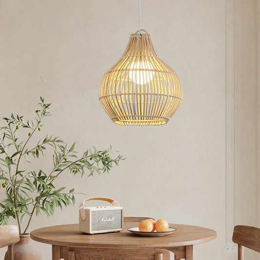 Dari rattan pendant light hanging over a wooden dining table
