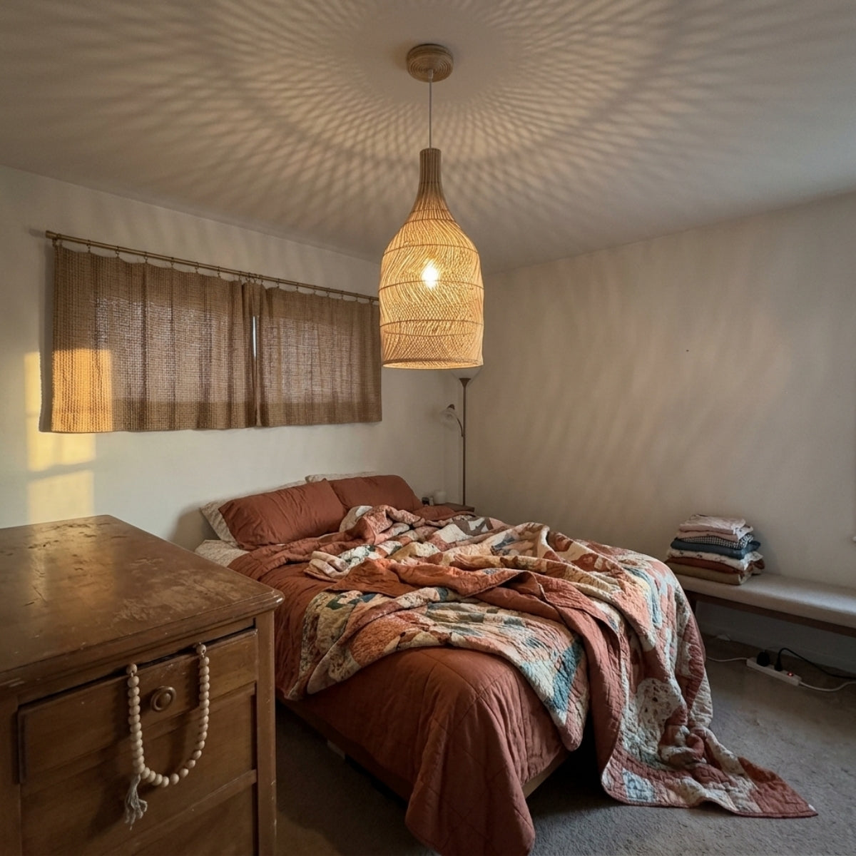 Embid Natural Rattan Ceiling Light in bedroom, 11.4-inch shade replacing a bedside lamp, open lower weave scattering soft light across ceiling and walls