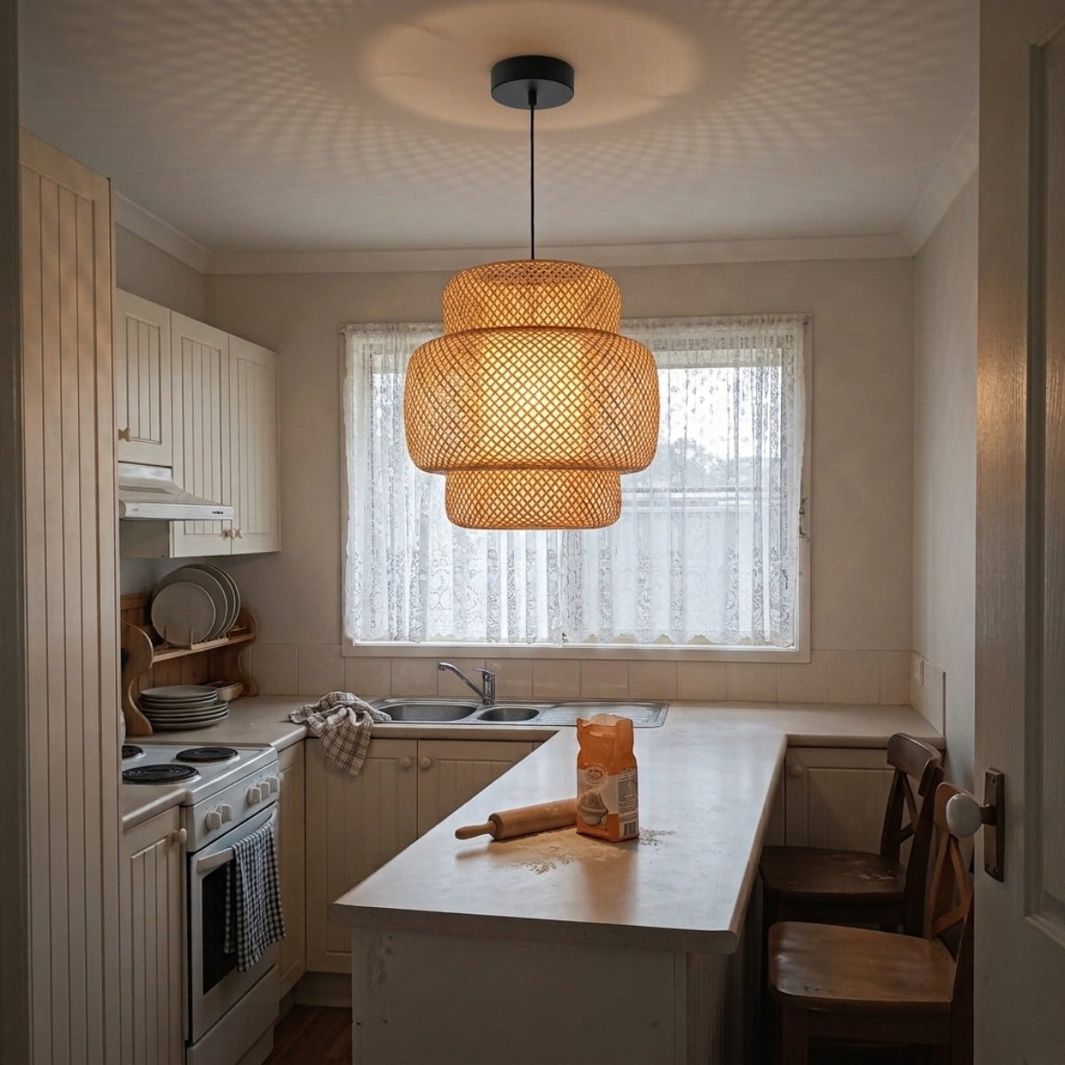 Enakshi Abstract Bamboo Pendant over kitchen island, clustered shades spanning the counter with layered bamboo strips lighting the prep surface evenly