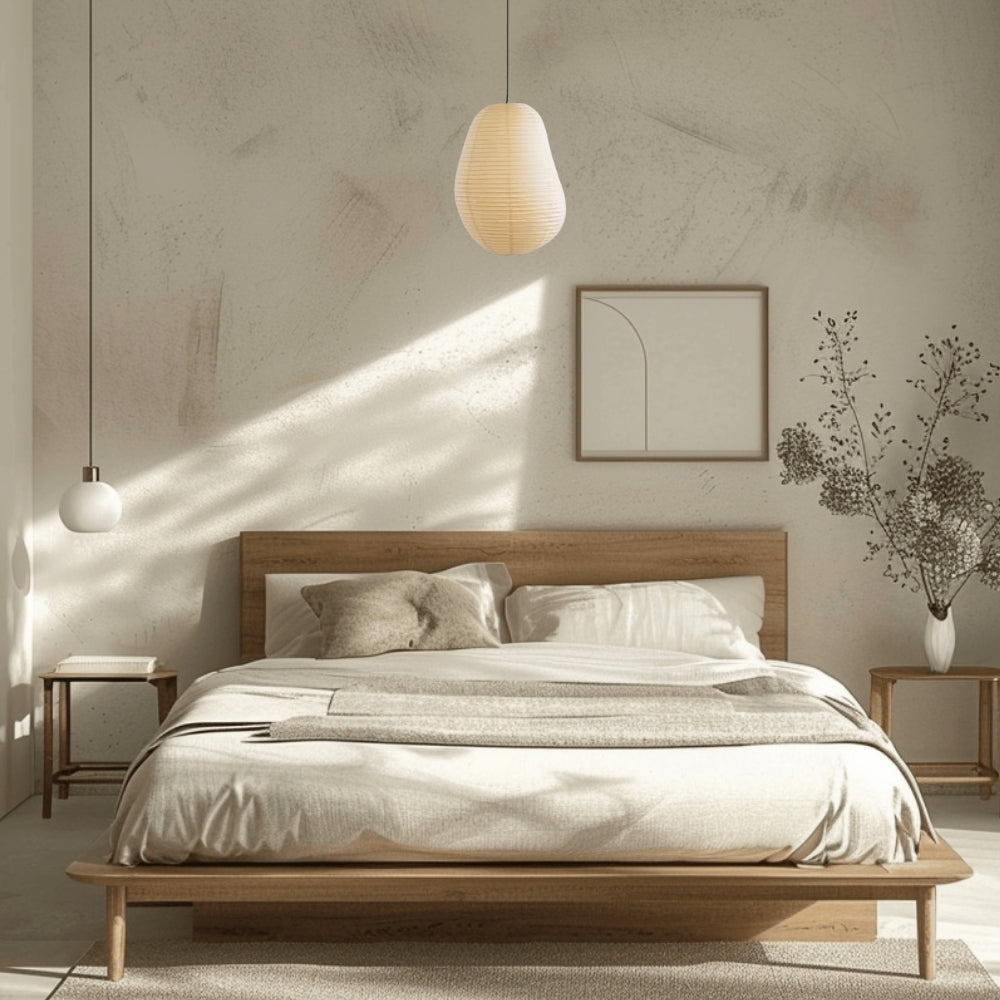 Isamu Noguchi Wabi Sabi Paper Pendant Light in bedroom, wide 16.5-inch lantern replacing a bedside lamp with a softer broader glow across the pillow area