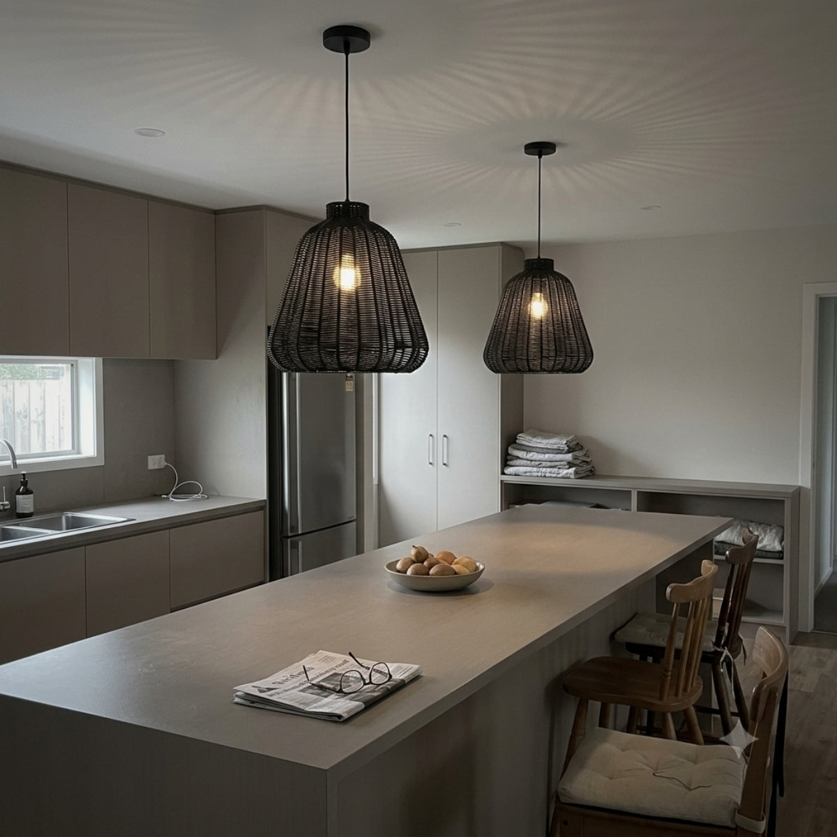 Kmart Black Wicker Rattan Pendant over kitchen island, clustered ribbed shades spaced evenly keep prep surfaces bright with soft organic shadow contours overhead