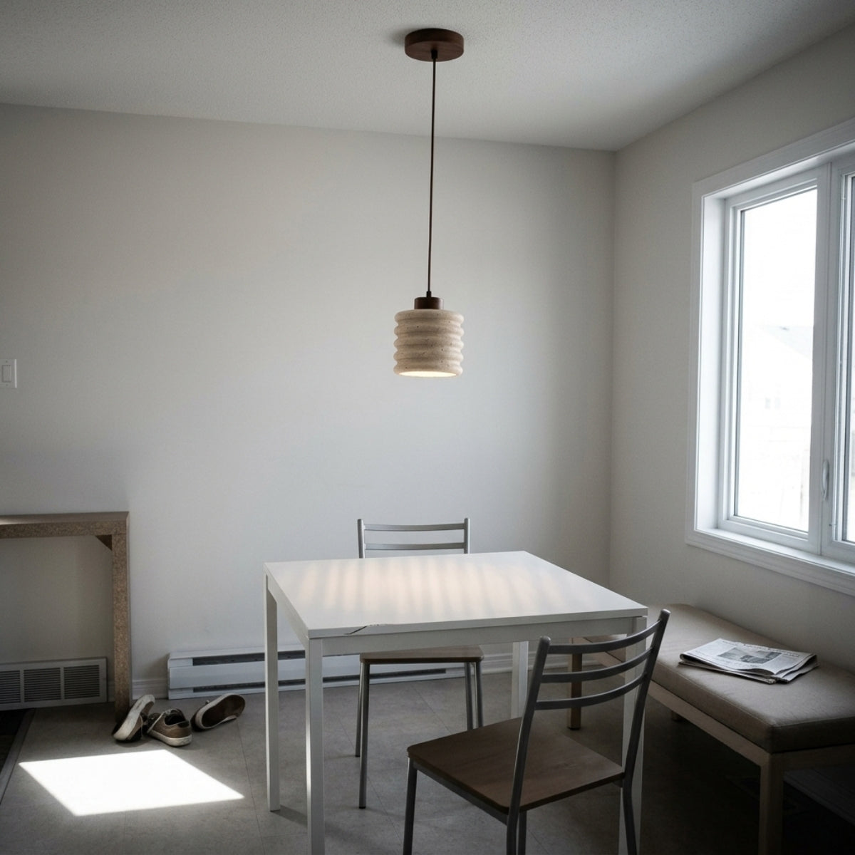 Komei Travertine Stone Pendant Light in dining room, small ridged shades in a row cover the table with warm light and no single glare point