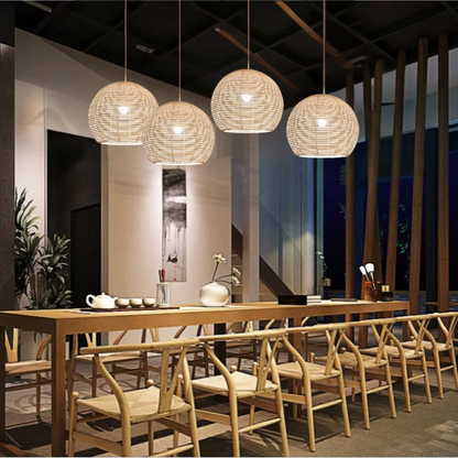 Manor Brook Verona Rattan Pendant Lights hanging above dining table