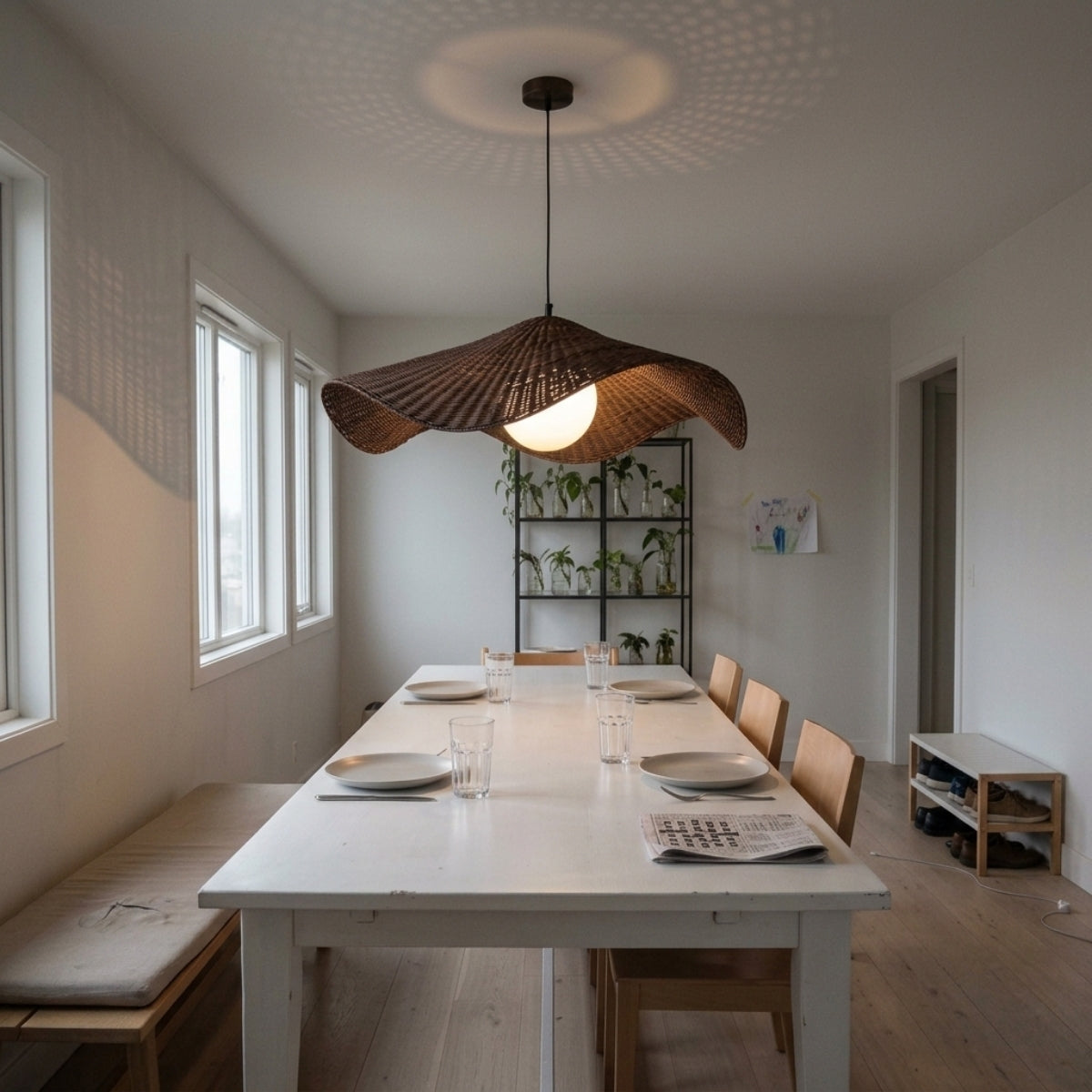 Matara Woven Wicker Rattan Pendant above dining table, wide dome spreading radial shadow pattern evenly without glaring into seated eye lines