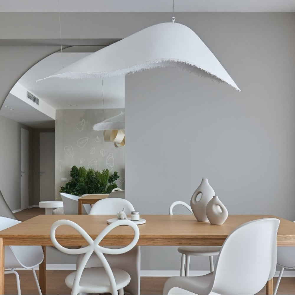 Moby Dick Wabi Sabi Pendant above dining table, fringed shade covering a standard table without glare at eye level, framing the place settings