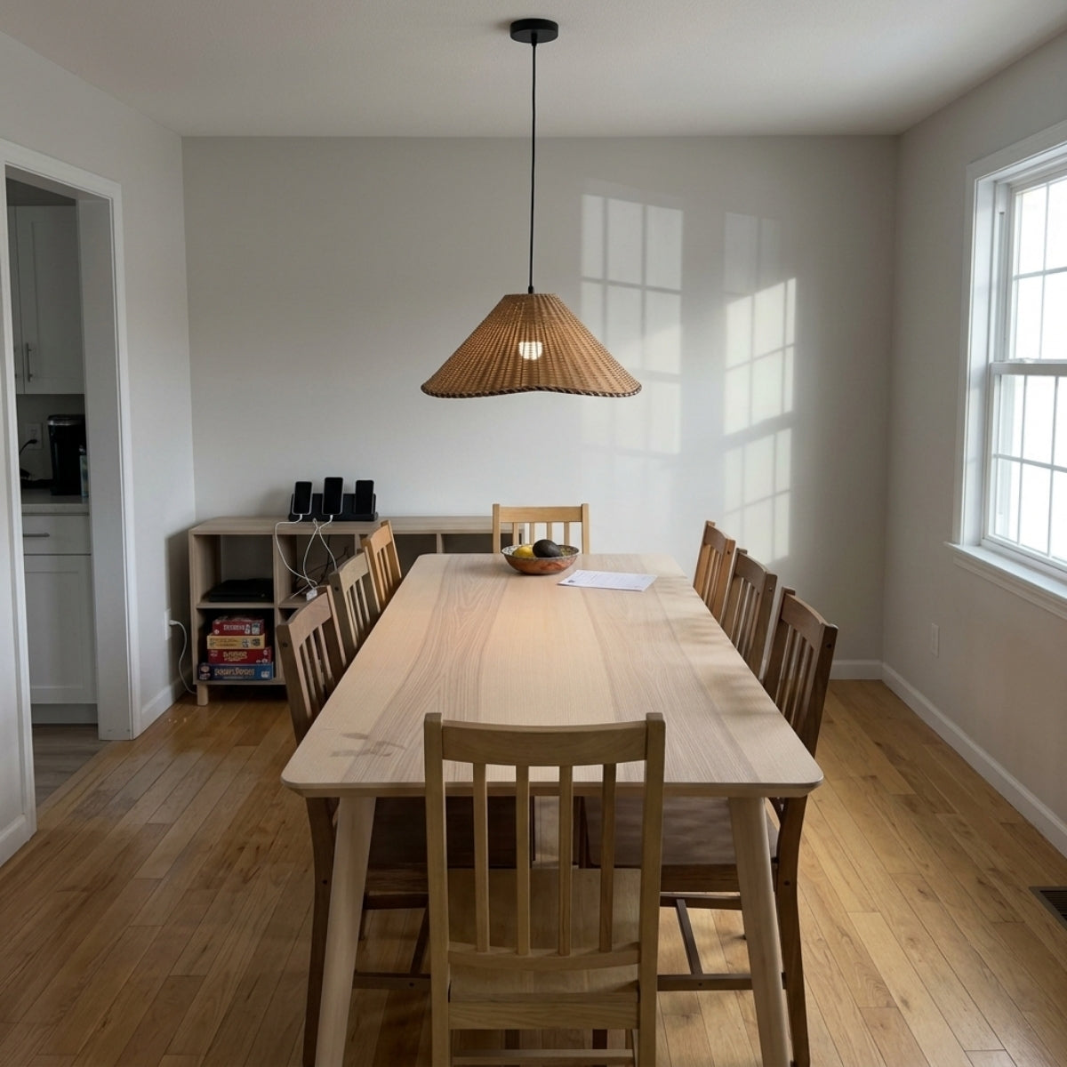 Oceania Rattan Pendant above dining table, 19.7-inch shade covering a standard six-seat table without crowding sightlines across the surface