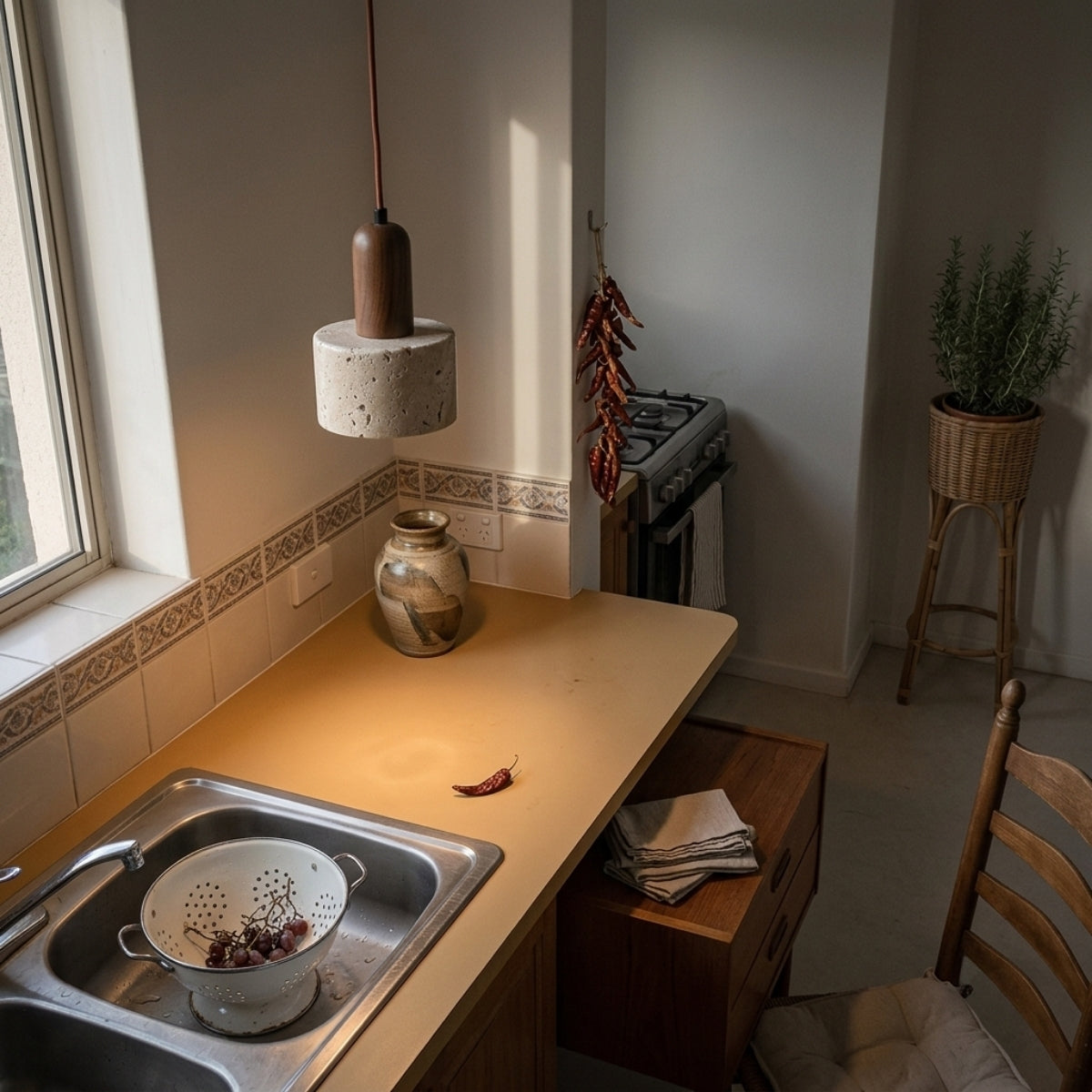 Ora Wabi Sabi Cylinder Pendant in kitchen island, two or three 4.7-inch stone cylinders clustered with staggered cord heights lighting the counter evenly