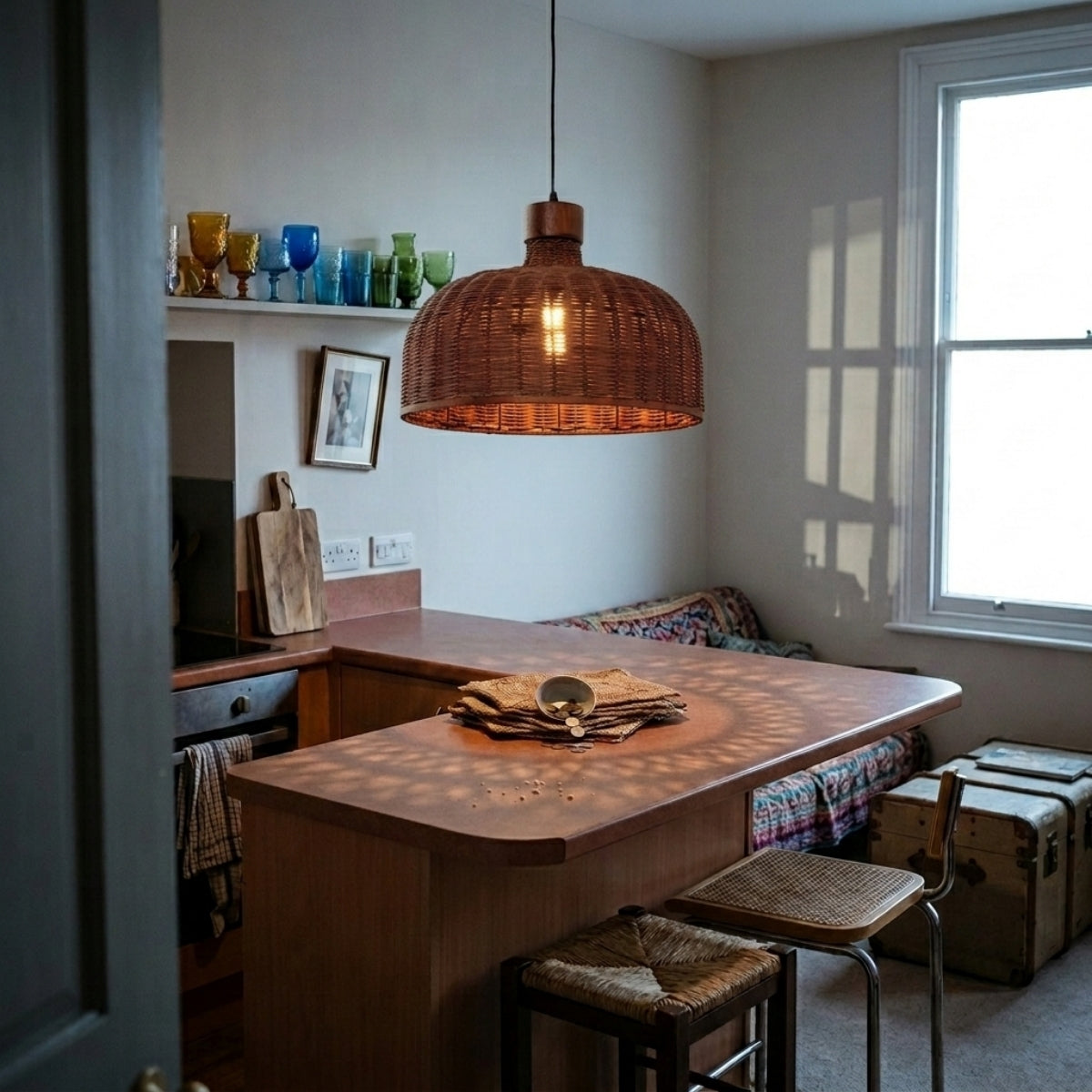Sago Round Wicker Rattan Pendant Light over kitchen island, clustered domes still throwing enough open-weave light onto the prep counter below