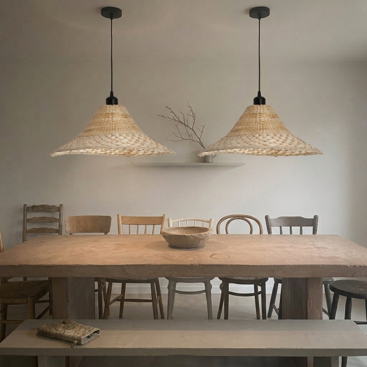 Savannah Bell Wicker Bamboo Pendant Light in dining room, bell shade covering the tabletop with a soft pool of light and no direct glare at eye level