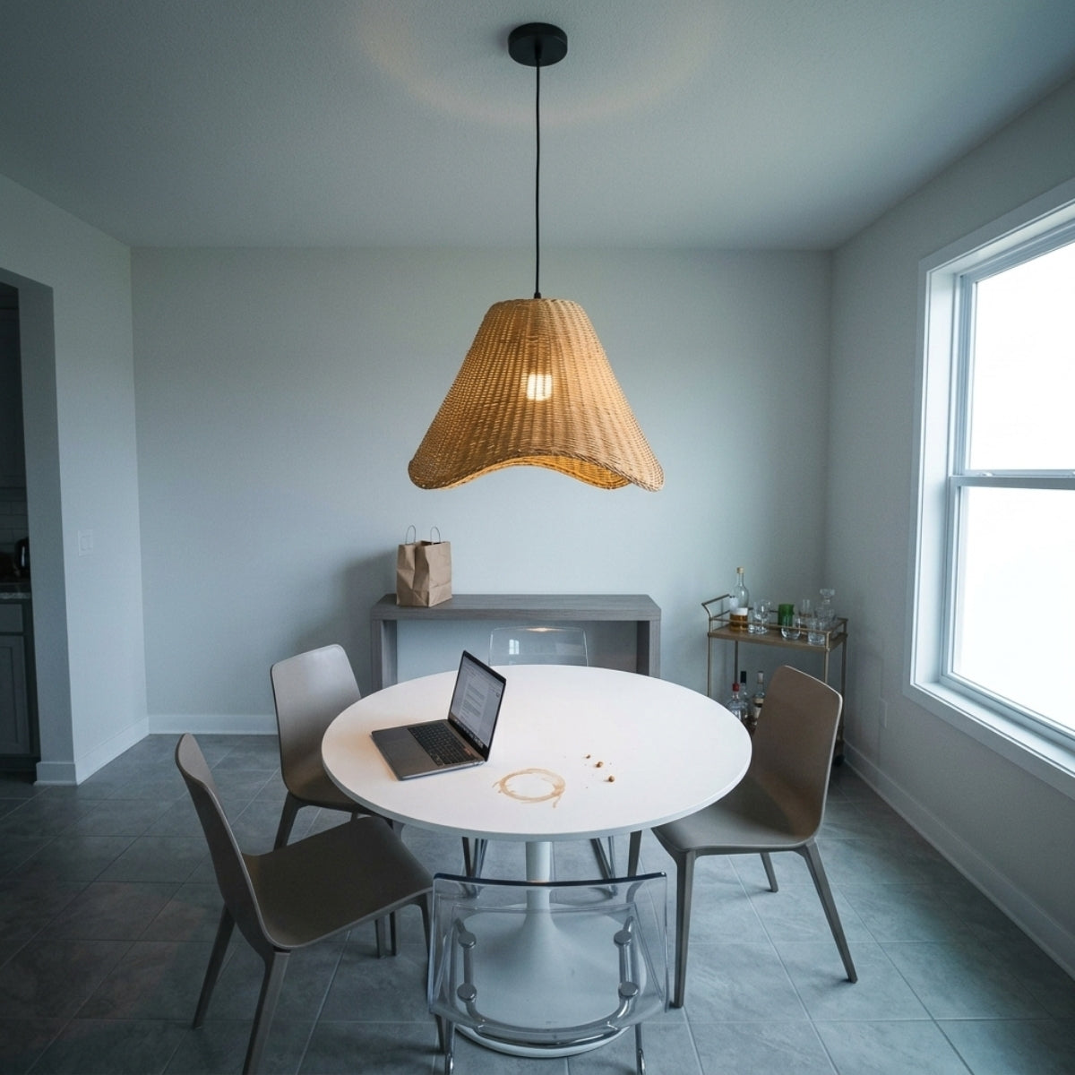Sutton Knotted Rattan Pendant Light above dining table, knotted rattan breaking light into a soft dappled pattern instead of a hard downlight glare