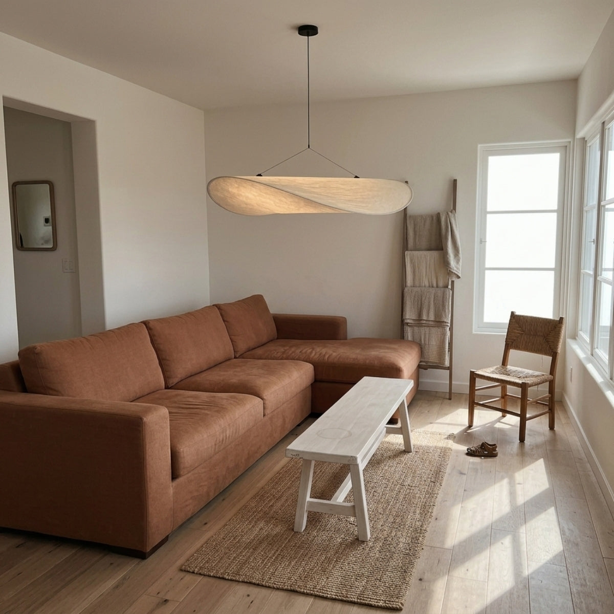 Tense Cloud Silk Pendant in living room, 31.5-inch cloud-like silk form anchoring the coffee table as one wide sculptural centerpiece for the seating area