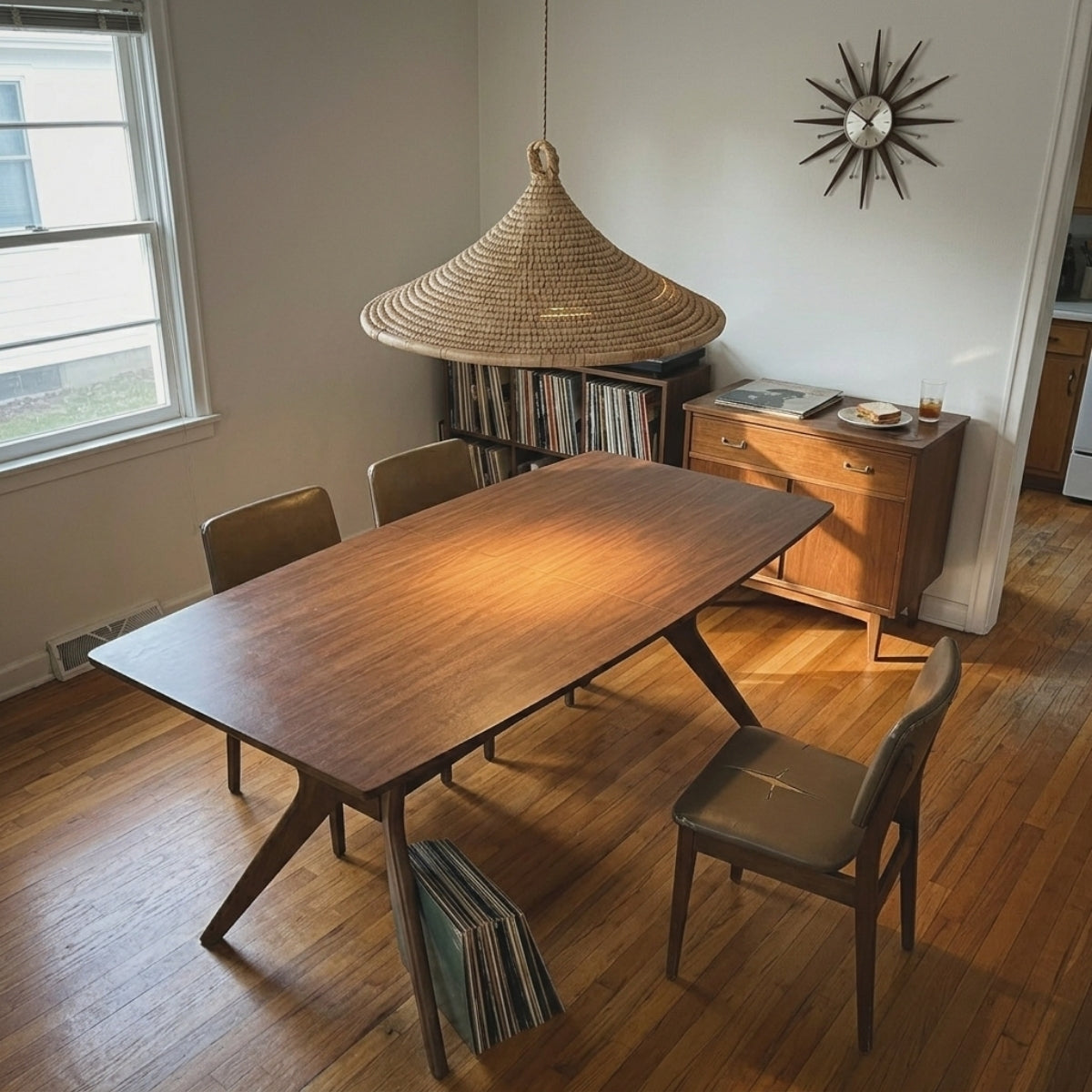 Yariah Cone Bamboo Rattan Pendant Light above dining table, wide cone base spreading light evenly across a six-seat table without glare at eye level