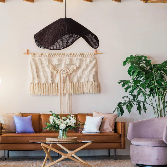 Adaya Black Rattan Pendant Light hanging in a Rustic Living Room