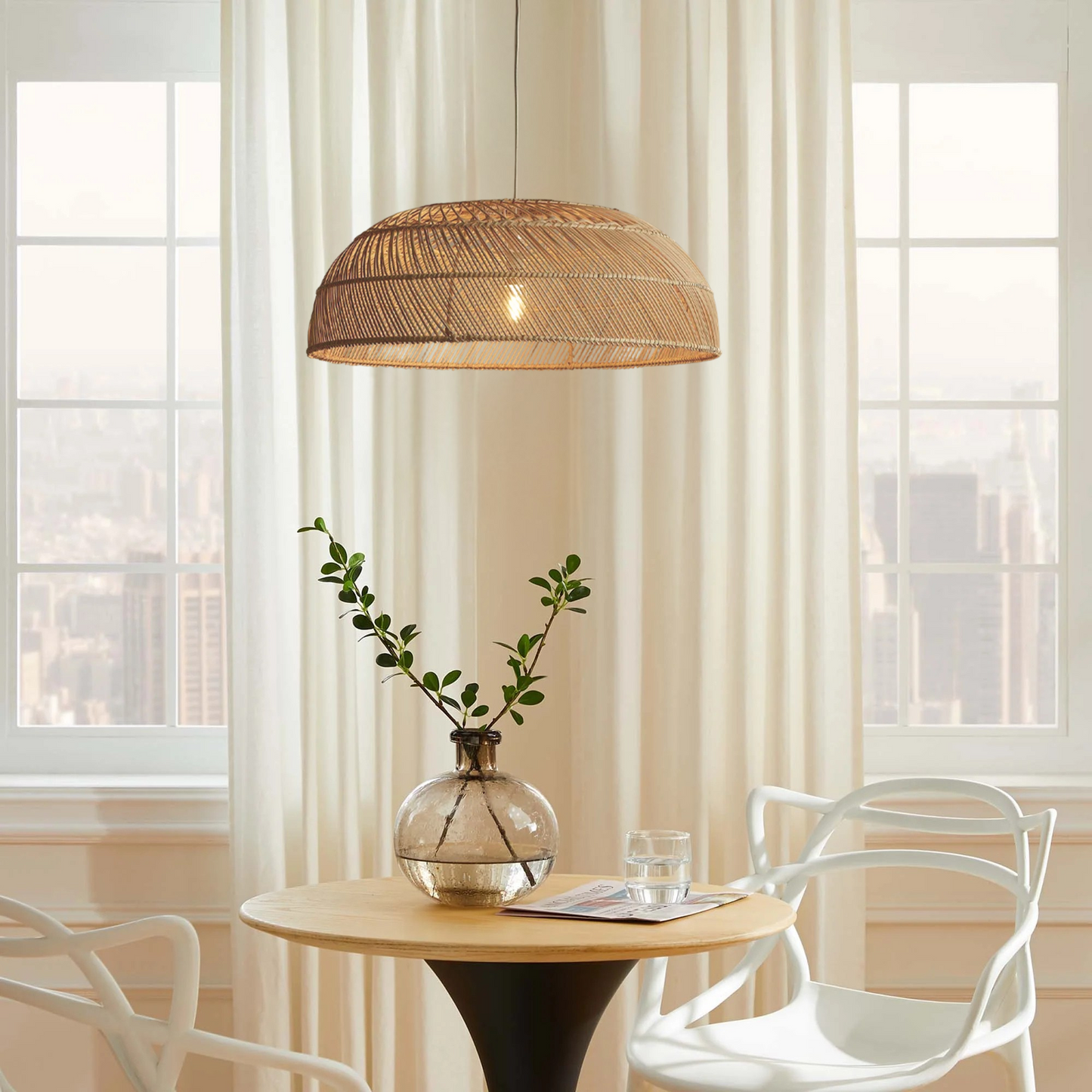 Amara Dome Rattan Pendant Light hangs over a Boho Dining table