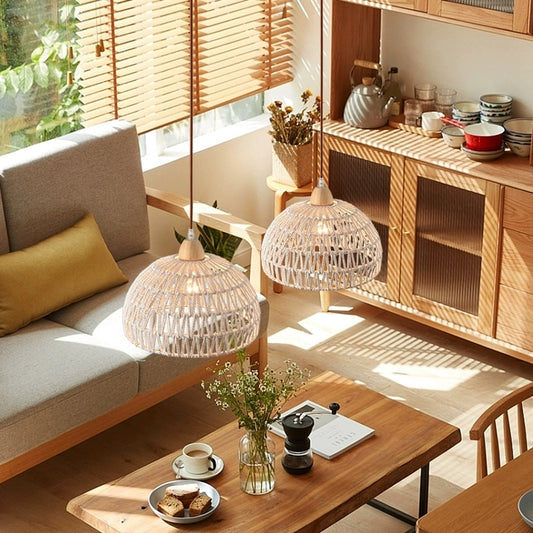 Campana Small White Rattan Basket Pendant Lights hang over Boho Living Room Table