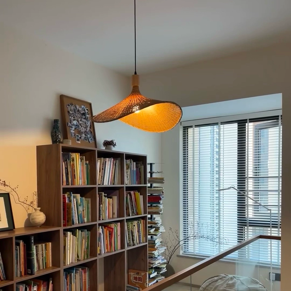 Ellie Hat 3 Light Rattan Pendant hangs over IndochinaLights Customer Home Library