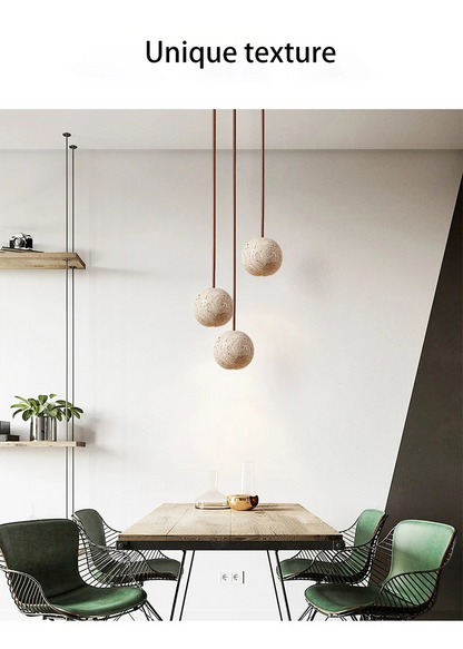 Fabien Wabi Sabi Globe Travertine Stone Pendant Light over Wooden Table