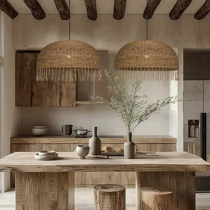 Frayed Rattan Dome Pendant Lights over Wabi Sabi Kitchen Island Table