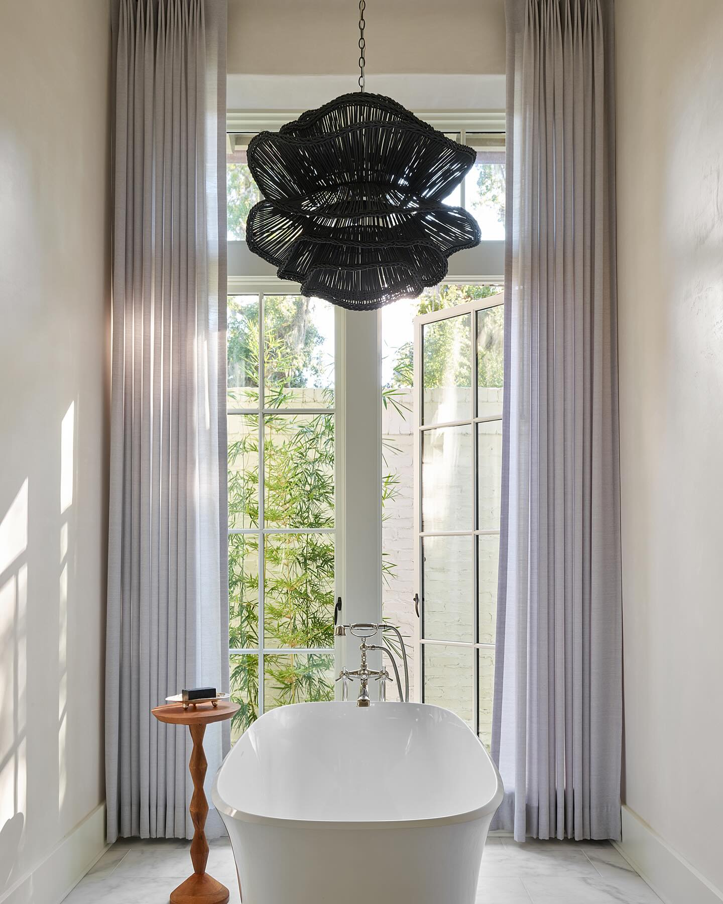 Made Goods Alondra Black Wavy Rattan Pendant Light Contrast the White Bathroom