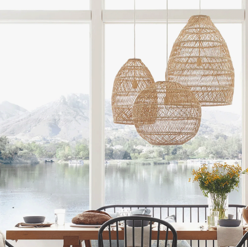 Minna rattan pendants hang over window dining table