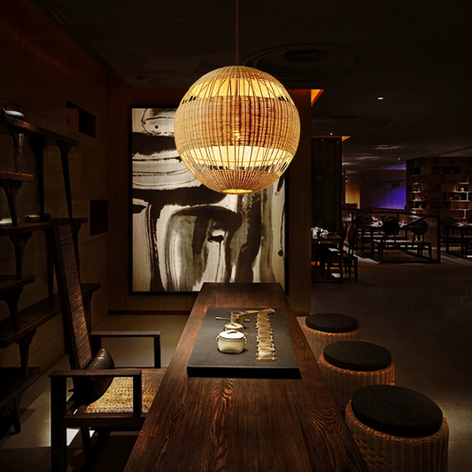 Palma round rattan pendant light hangs over Dining Table