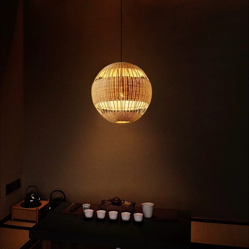 Palma round rattan pendant light hangs over Zen-style coffee table
