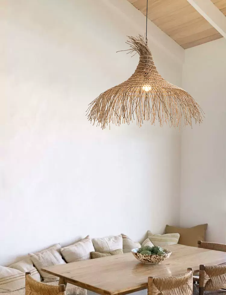 Pipa Tassel Rattan Pendant Light hangs over Minimalist Table