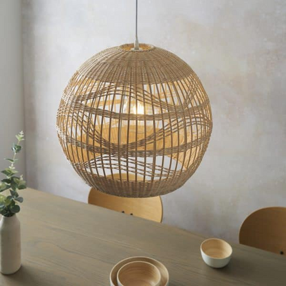 Rita Round Rattan Bamboo Pendant Light hangs over dining table