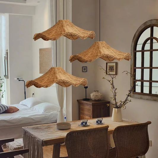 Set 3 of Ariel Rattan Wave Pendant Lights over a Wooden Table