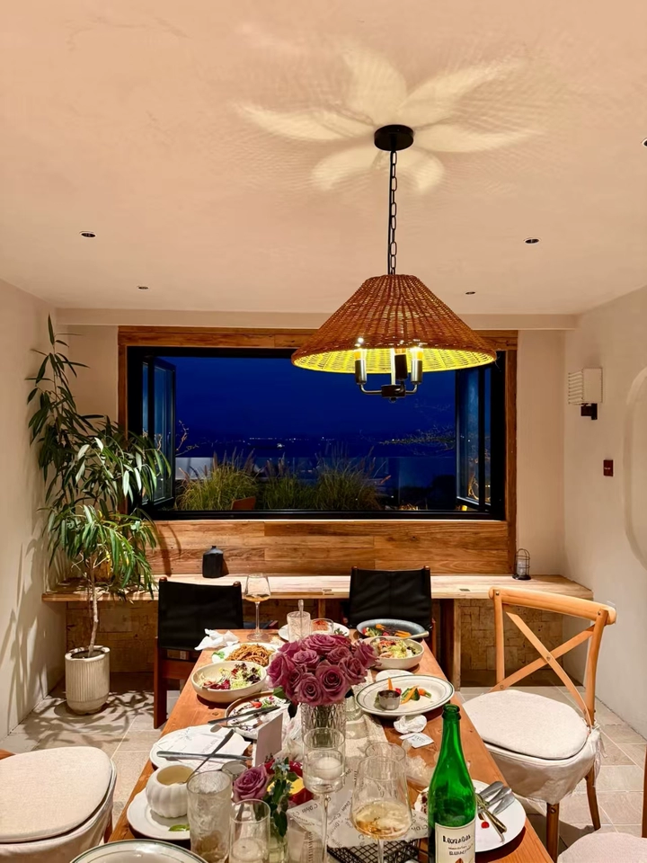 Timor rattan drum wicker pendant light over dining table