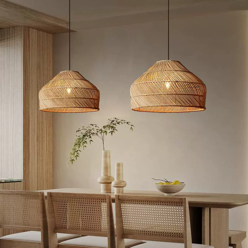 Two Cocoa Rattan Dome Woven Hanging Lights above Wabi Sabi Dining Table