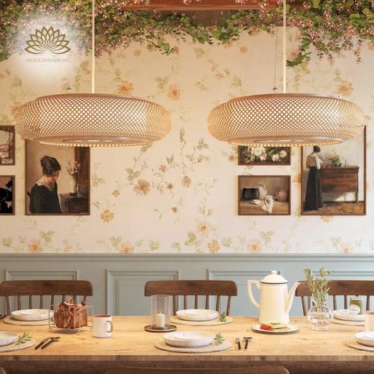 Two large oval Oukaning woven bamboo pendant lights above a long wooden dining table in a floral Scandi room