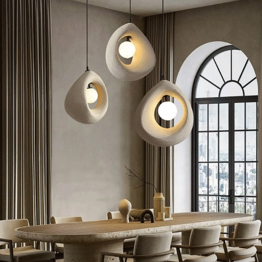 white wabi sabi cave surround pendant light above dining table